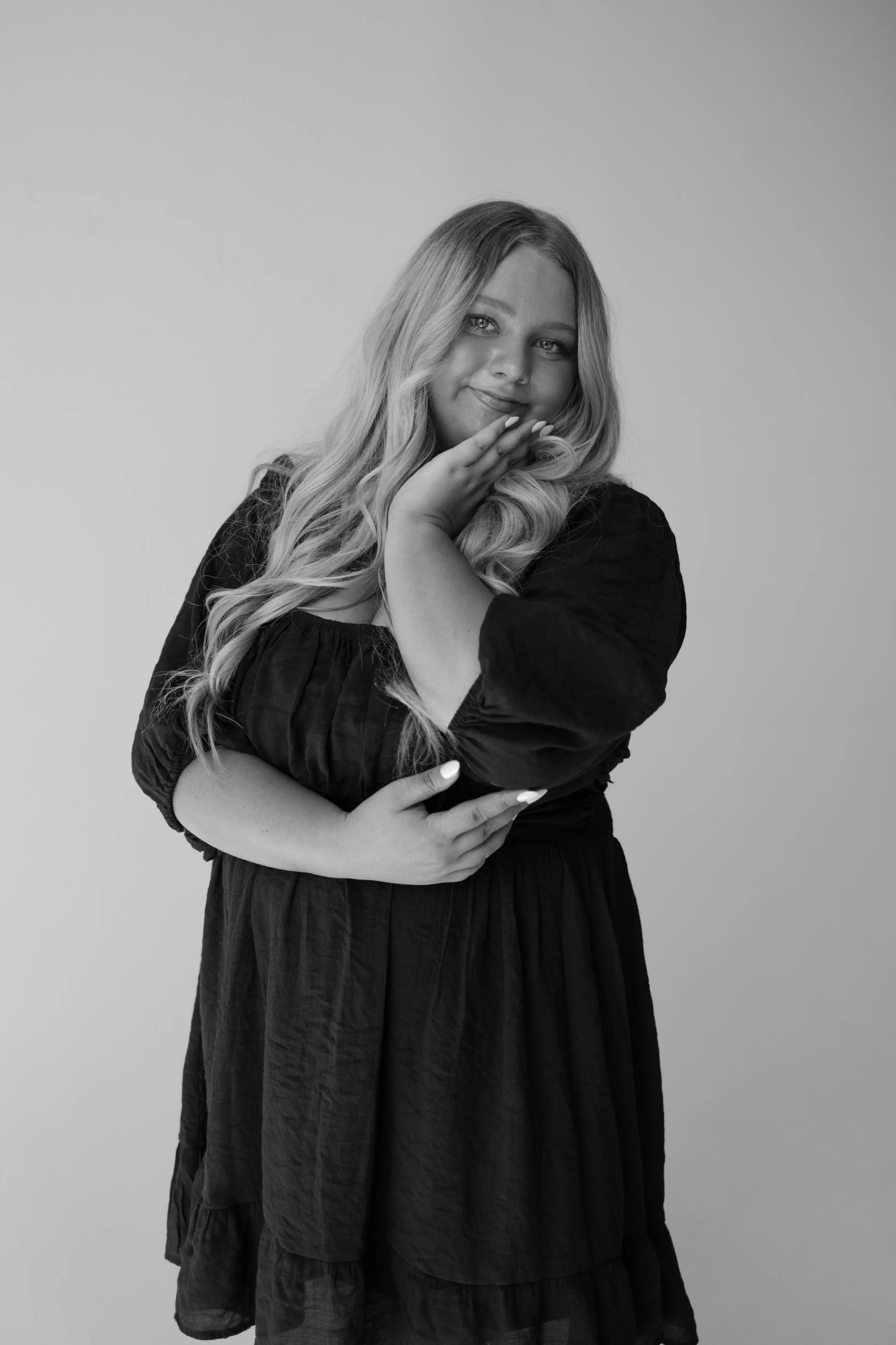 Black and white photo of Brynelle smiling and posing