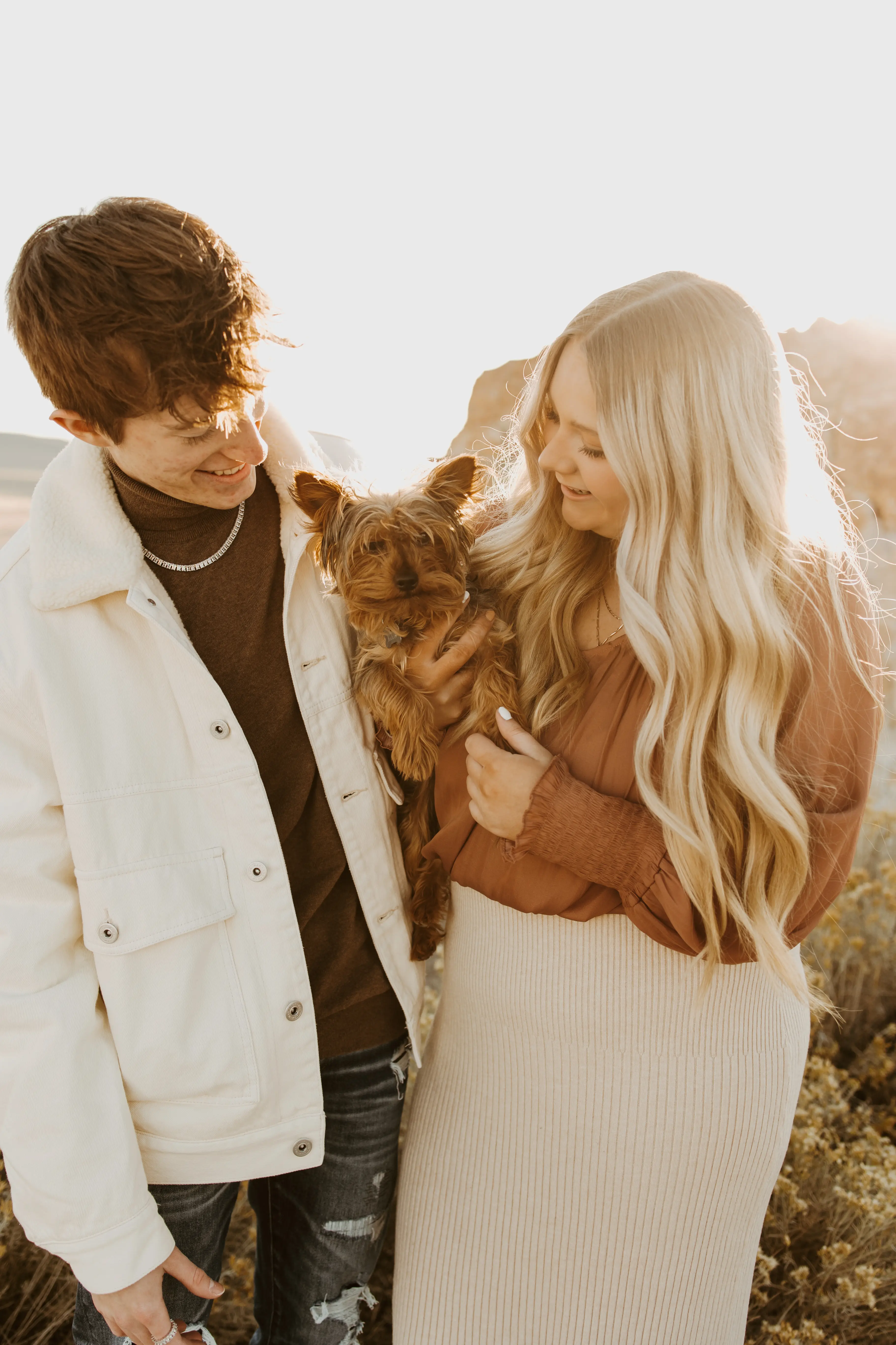 Brynelle, her boyfriend (Tate), and their dog (Koda), all posing together for a family photo, with Tate and Brynelle laughing at Koda