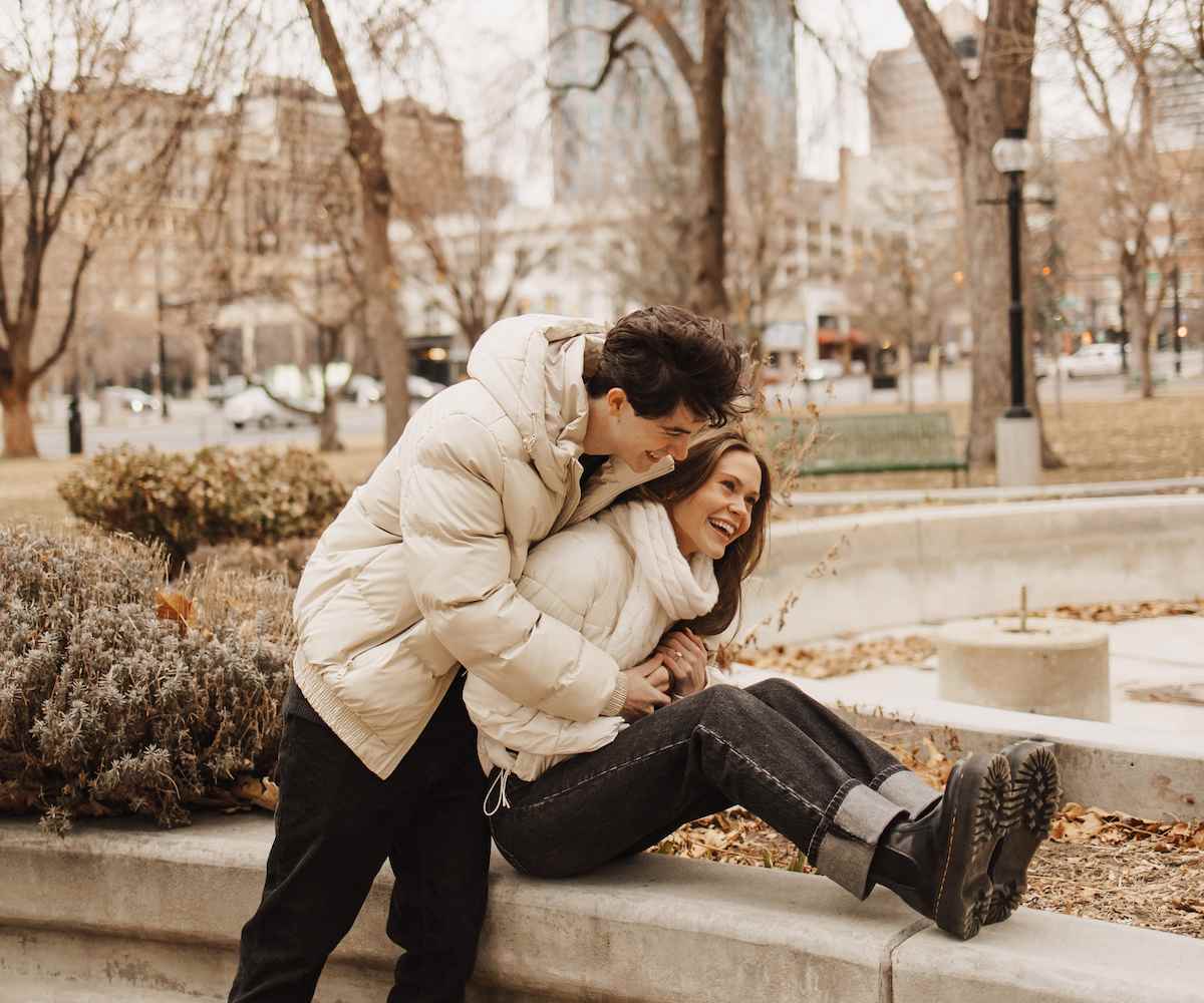 Girl on guy's shoulders looking down at him